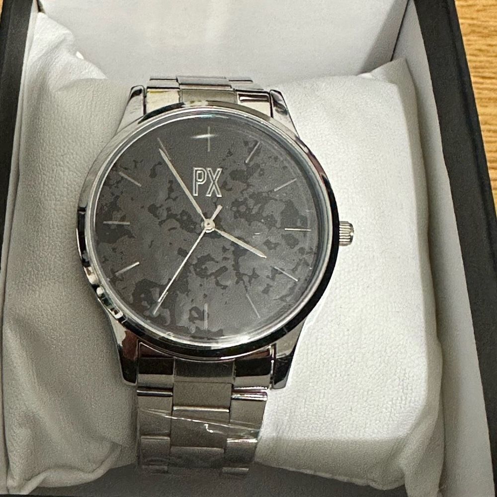 PX silver watch with black face. A687